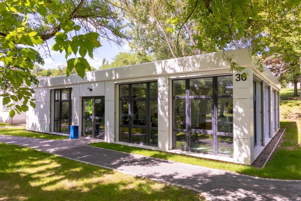 a building with glass doors and a walkway