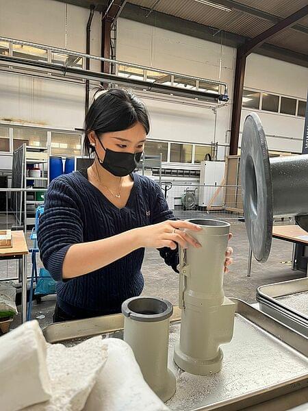 Yuwei Chang checks a component