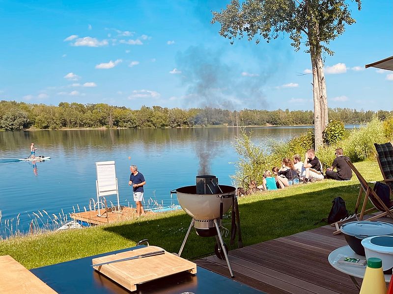 the barbecue is burning on the shore of the gravel lake