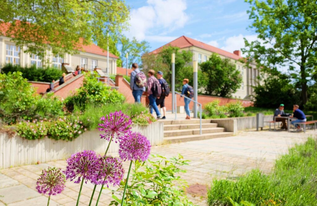 a group of people walking up stairs in front of buildings