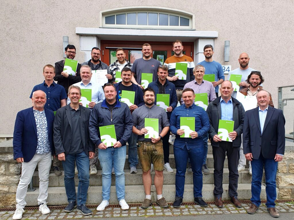 a group of people holding green papers