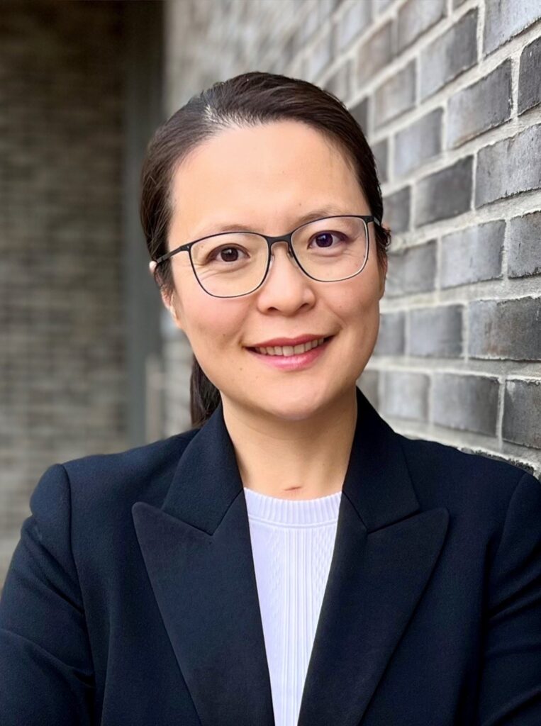 a woman wearing glasses and a suit