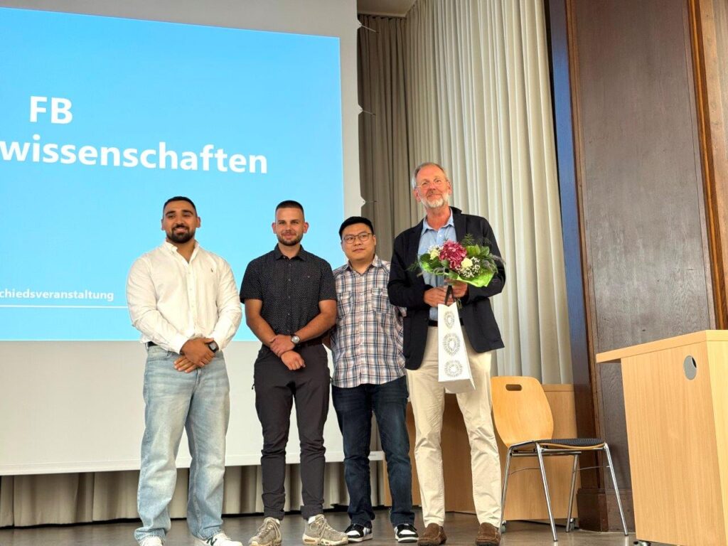 a group of men standing in front of a projector screen