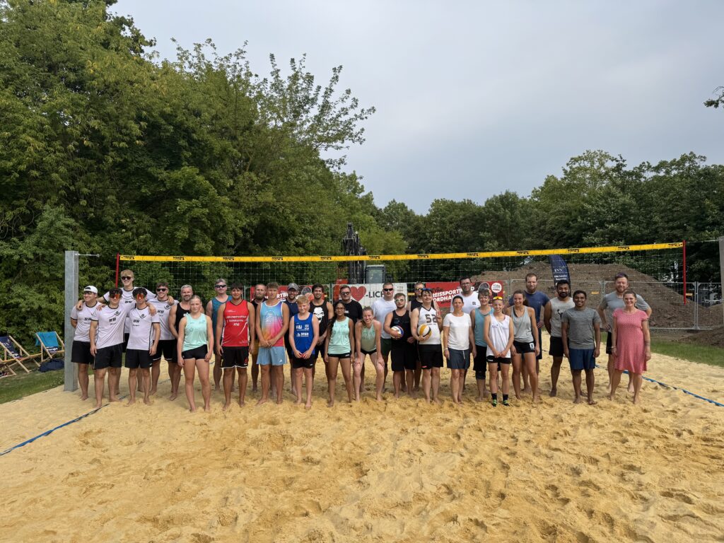 a group of people standing in a line in front of a yellow net