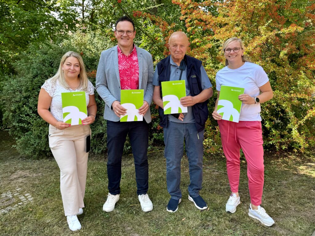 Group photo with green folders.