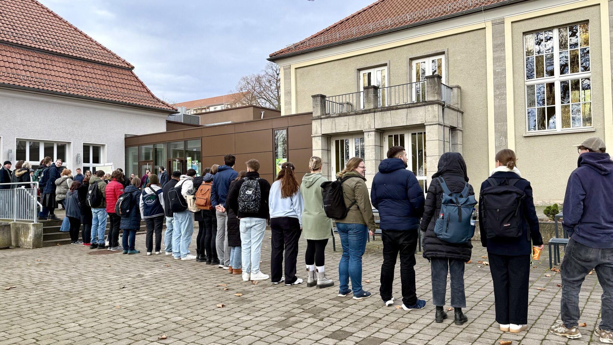 People stand in a long queue.