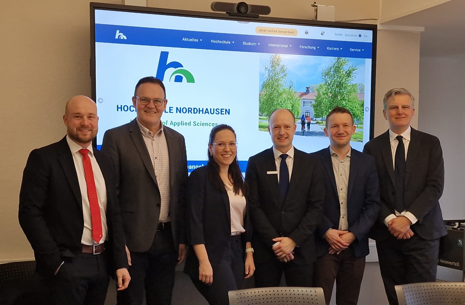 Gruppenfoto vor Präsentationstafel.